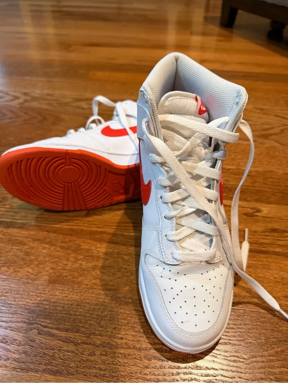 Nike White High-Top Sneakers with Orange-Red Swoosh